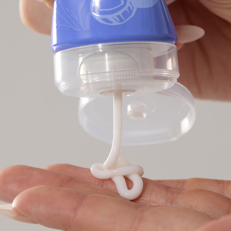 Close-up of hand cream being squeezed from its tube onto fingers.&nbsp;&nbsp; image number null
