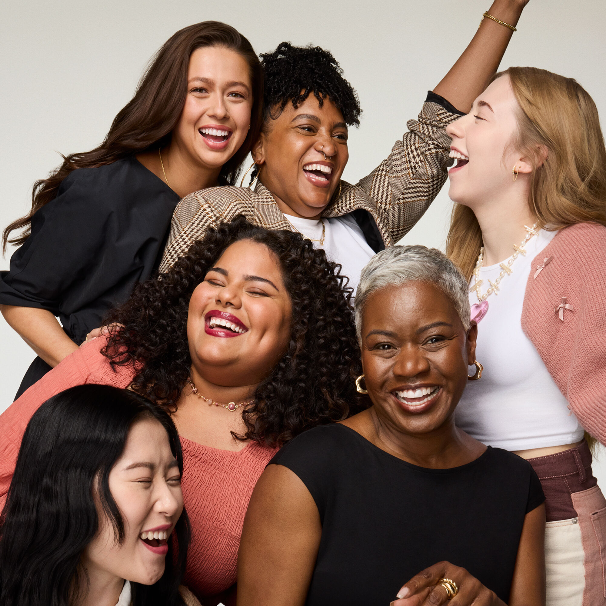 A group of women laughing and smiling together